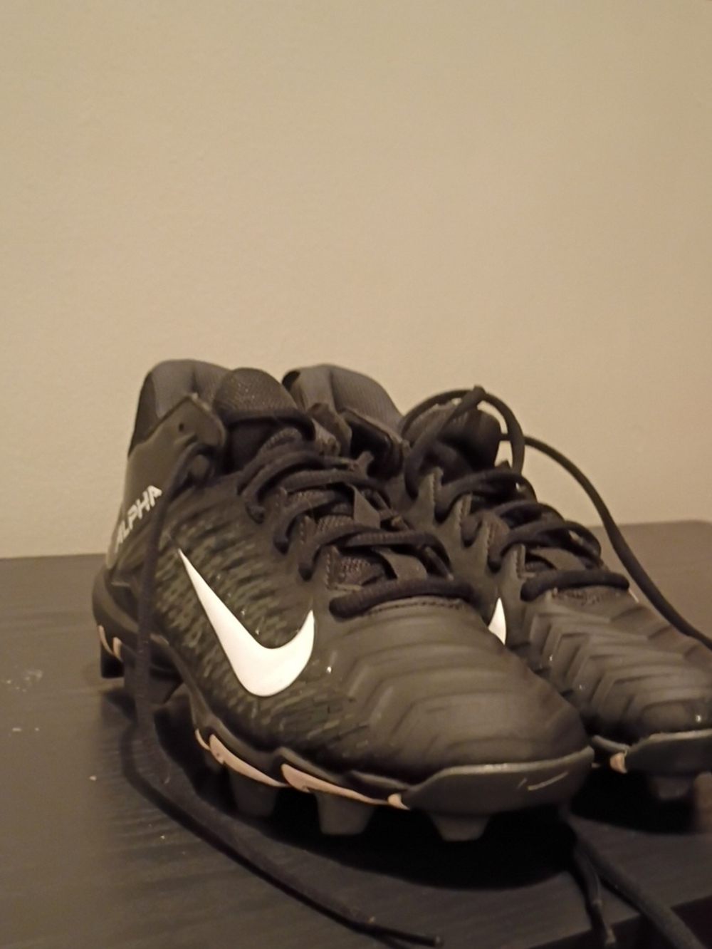 Nike Black Kids Soccer Cleats with White Swoosh and Light Tan Accents